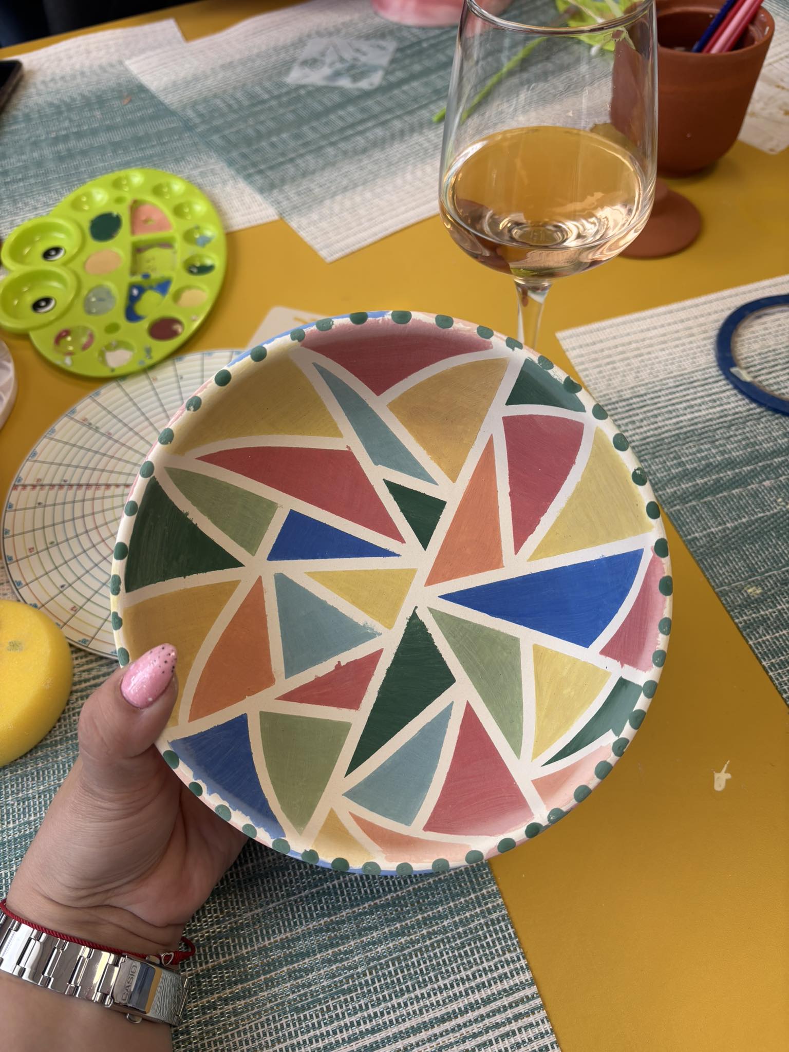 Shelves of handmade cream, terracotta and sage ceramic mugs in the Glinity studio